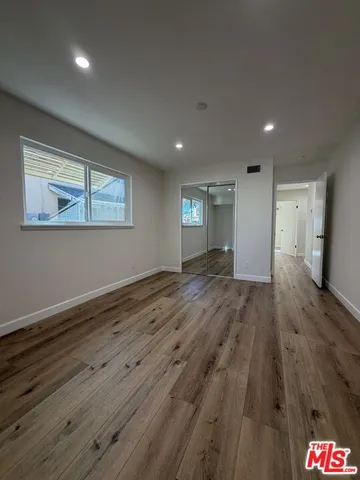 a view of a porch with furniture and potted plants