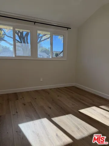 a view of a patio with table and chairs and potted plants