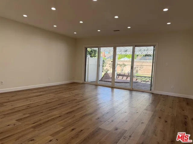 a view of a room with wooden floor and outdoor view