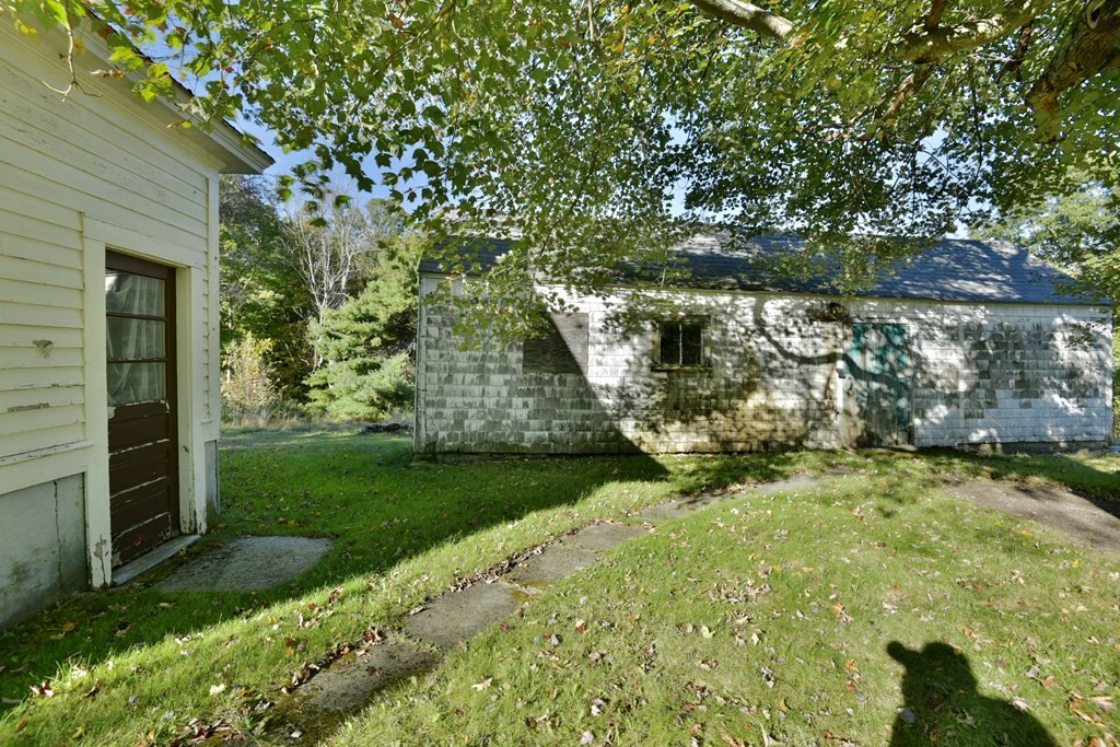 563 Mendon Road Whitinsville, MA 01588 - Photo 17 of 30 a view of a garden with a bench