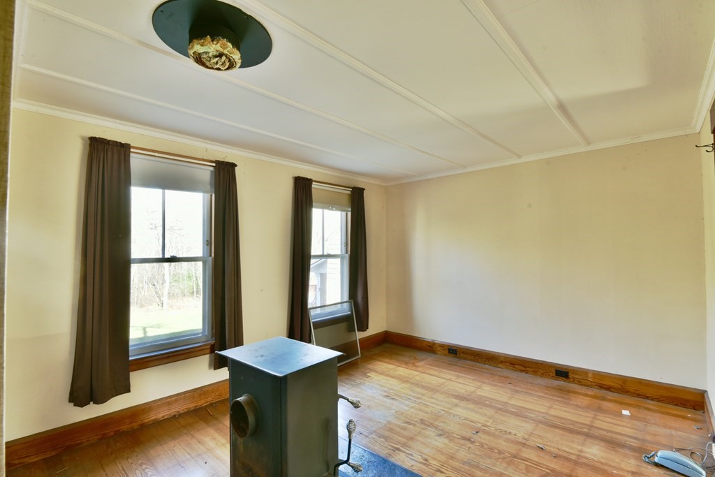 563 Mendon Road Whitinsville, MA 01588 - Photo 20 of 30 a room with window and wooden floor