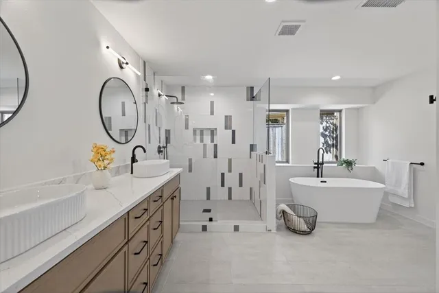 a spacious bedroom with a bed and a couch