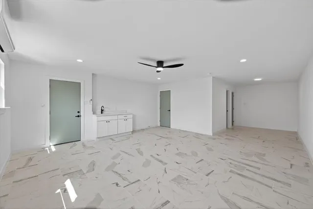 a bathroom with a bathtub sink vanity mirror and toilet