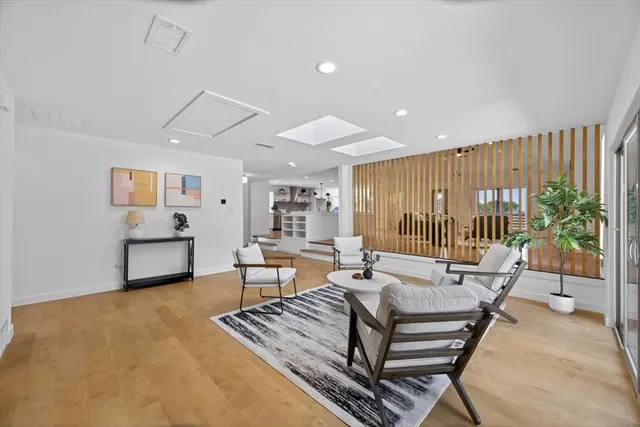 a living room with furniture and a potted plant