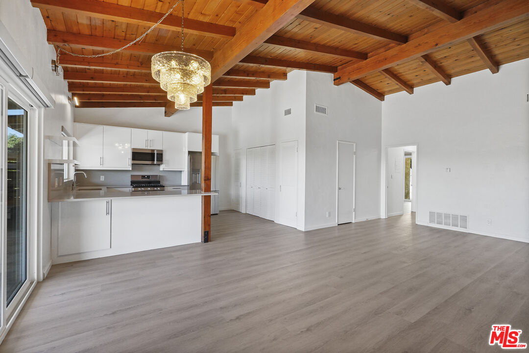 31259 Bailard Road Malibu, CA 90265 - Photo 7 of 41 a view of a kitchen with stainless steel appliances granite countertop a refrigerator and a stove top oven
