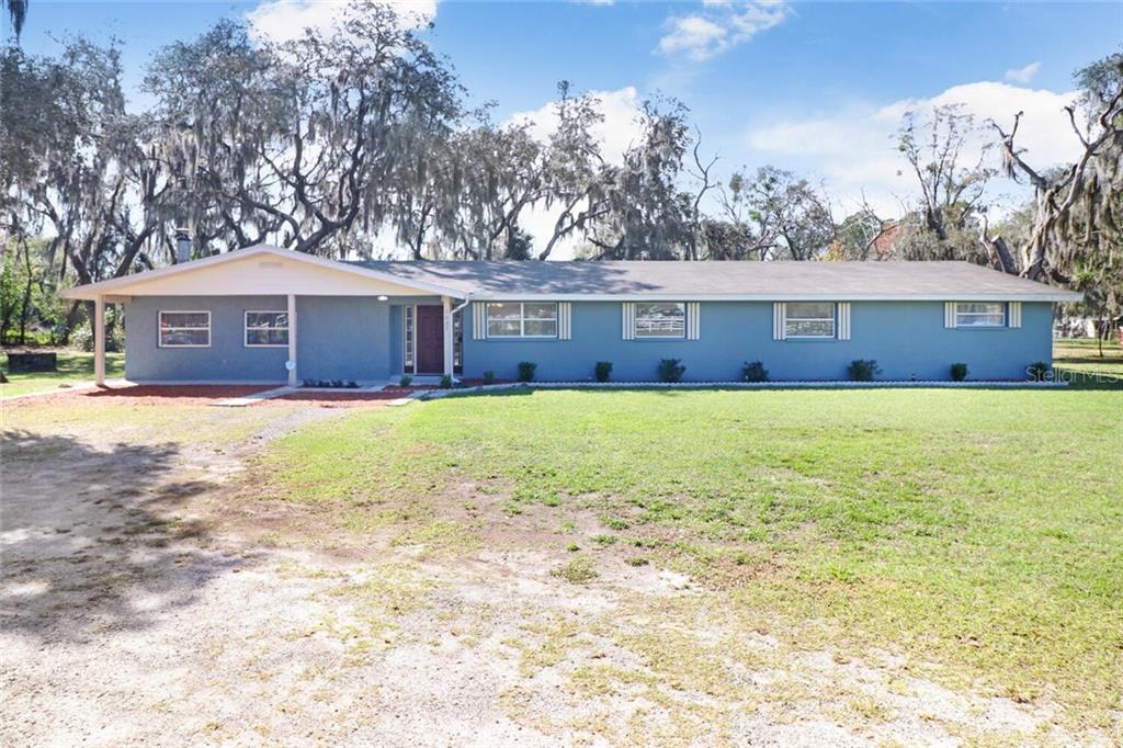 7625 North Socrum Loop Road Lakeland, FL 33809 - Photo 1 of 1 a view of a house with a yard and trees