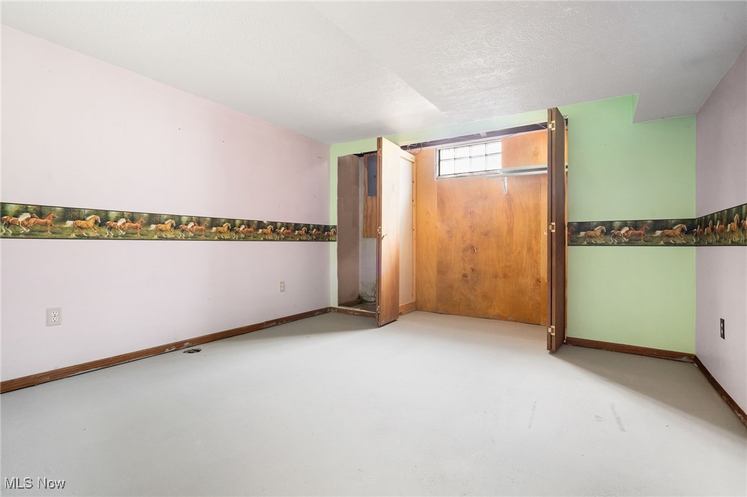 4727 15th Street Northwest Canton, OH 44708 - Photo 28 of 37 Unfurnished bedroom with a closet and finished concrete floors