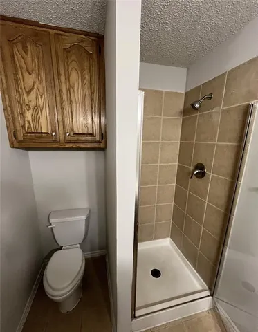 a bathroom with a toilet and a shower