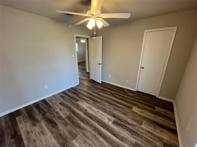 a view of a room with wooden floor