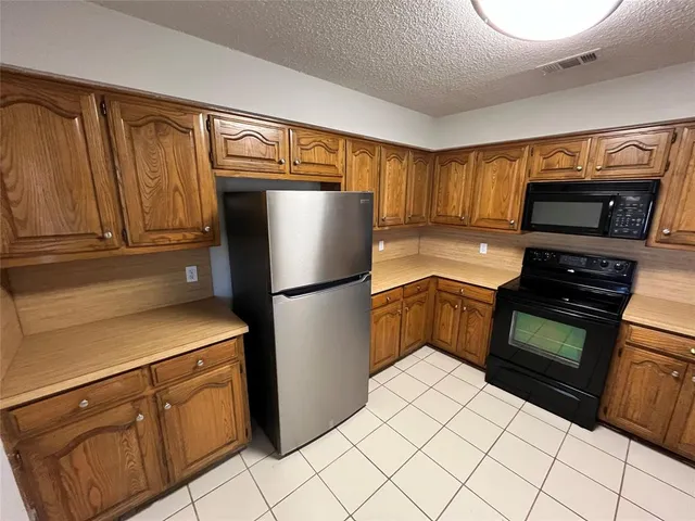 a kitchen with stainless steel appliances kitchen island granite countertop a sink and cabinets
