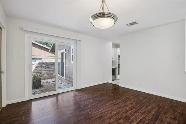 a view of wooden floor and window in a room