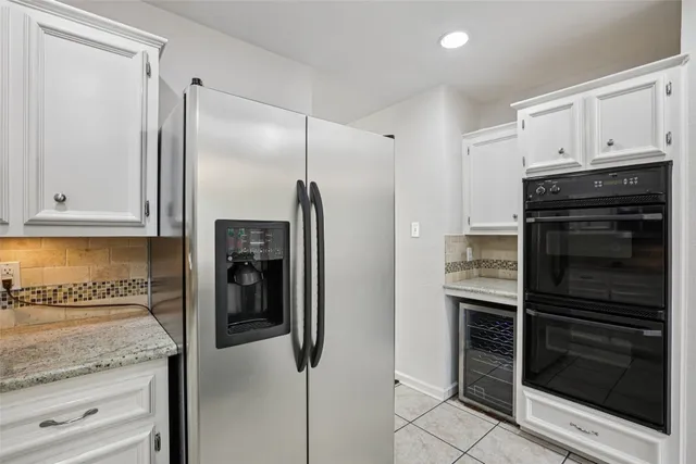 a kitchen with granite countertop a refrigerator and a stove