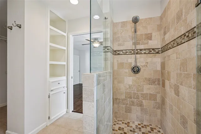 a bathroom with a shower and a glass door