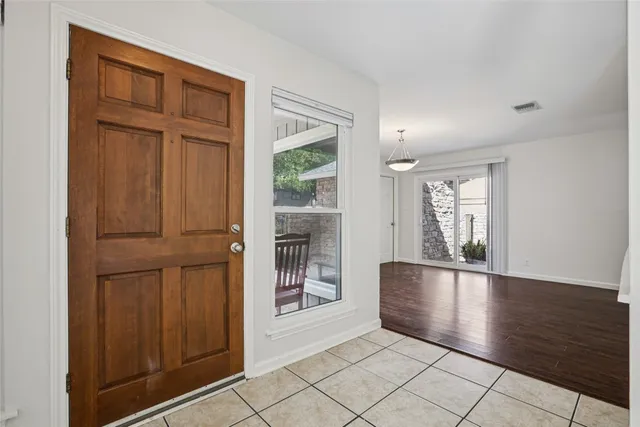 an empty room with windows and cabinet