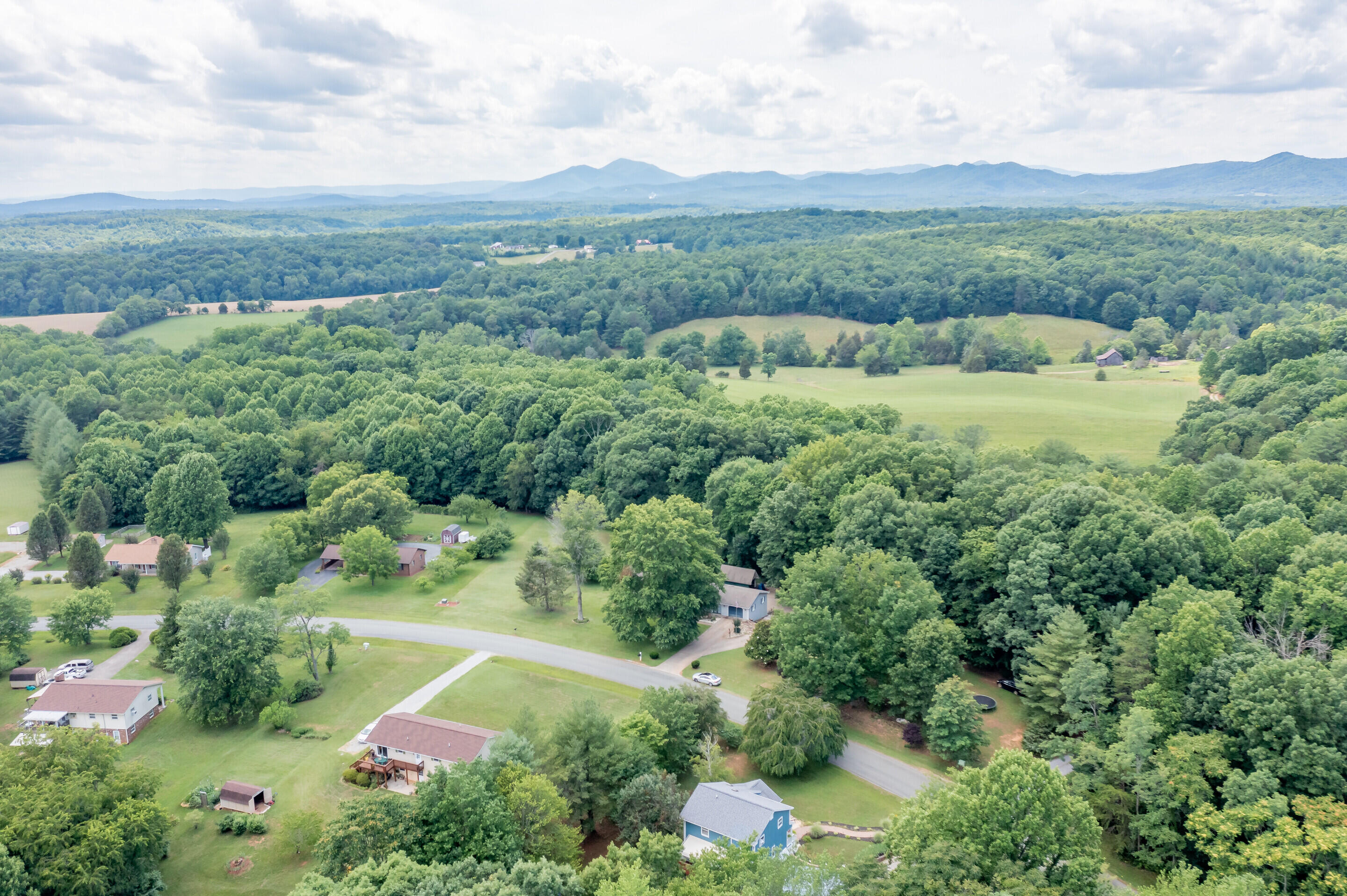 1096 Farmington Road Hardy, VA 24101 - Photo 48 of 54 an aerial view of green landscape with trees houses and mountain view