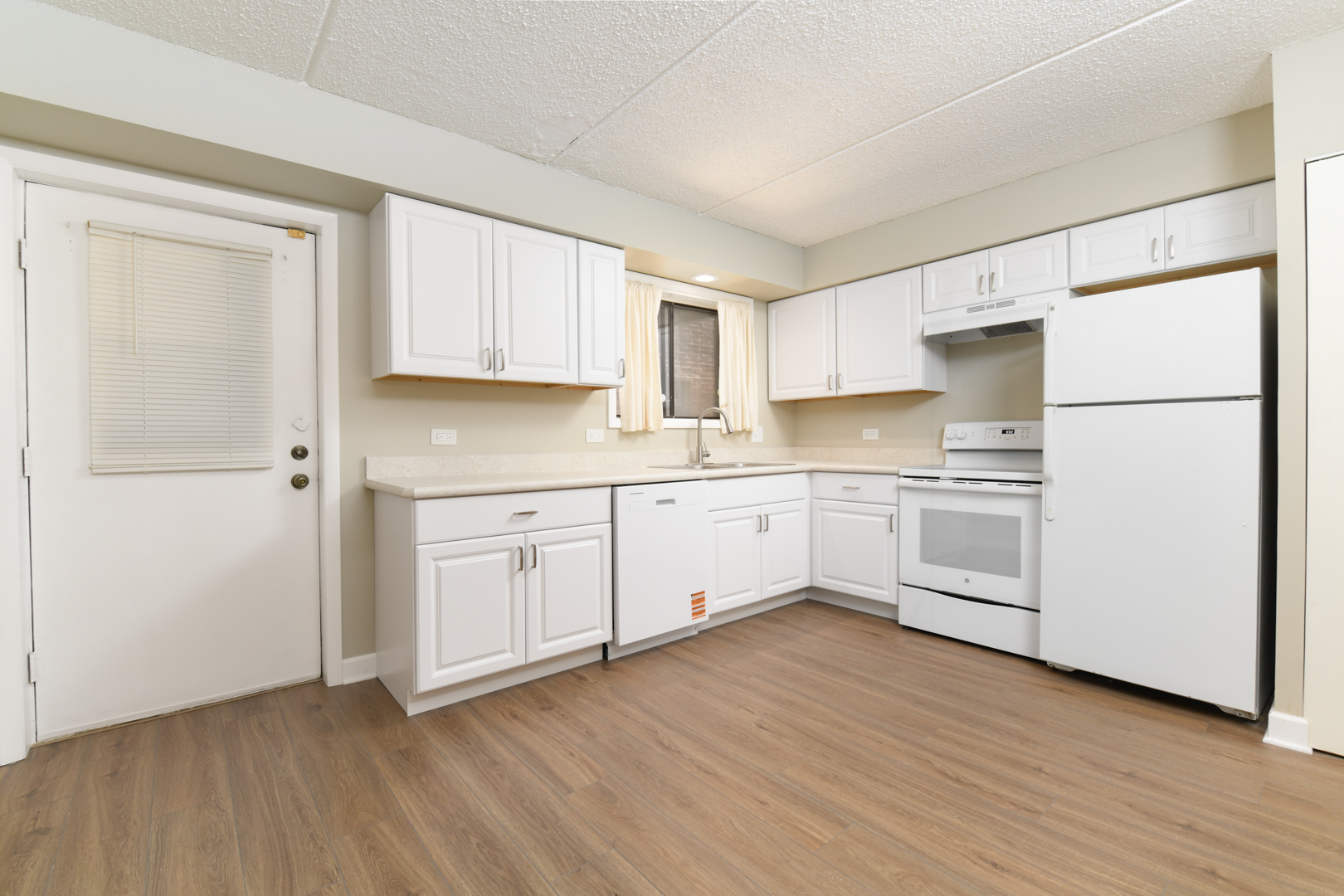 953 North Rohlwing Road, Unit GB Addison, IL 60101 - Photo 11 of 25 a kitchen with white cabinets white appliances and sink
