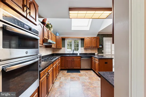 a kitchen with a table and chairs in it
