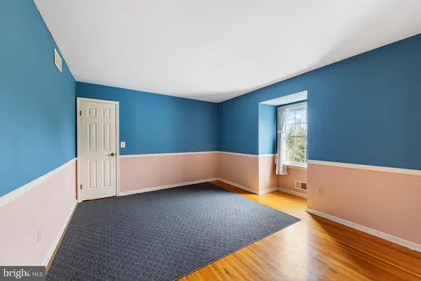 a bedroom with furniture and a flat screen tv