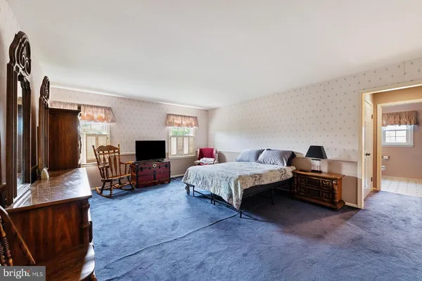 a bedroom with a bed and a couch