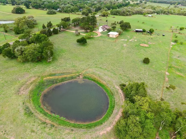 an aerial view of a house with a yard