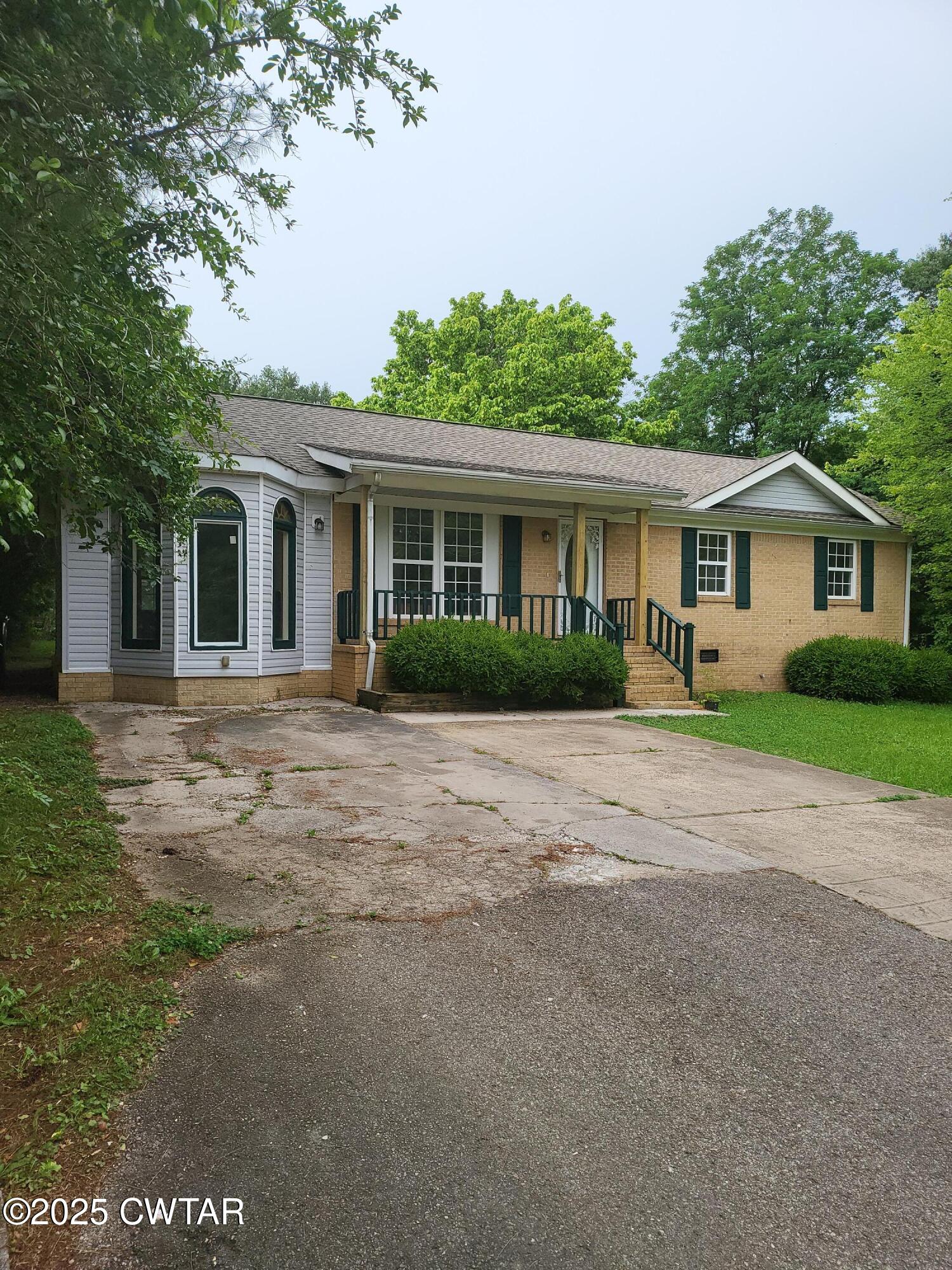 200 Cross Street Bolivar, TN 38008 - Photo 1 of 12 a front view of house with yard and green space