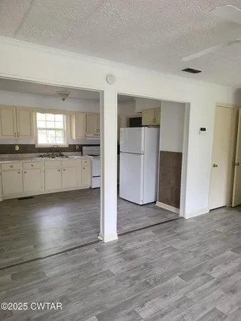 a view of a kitchen with a sink and dishwasher cabinets