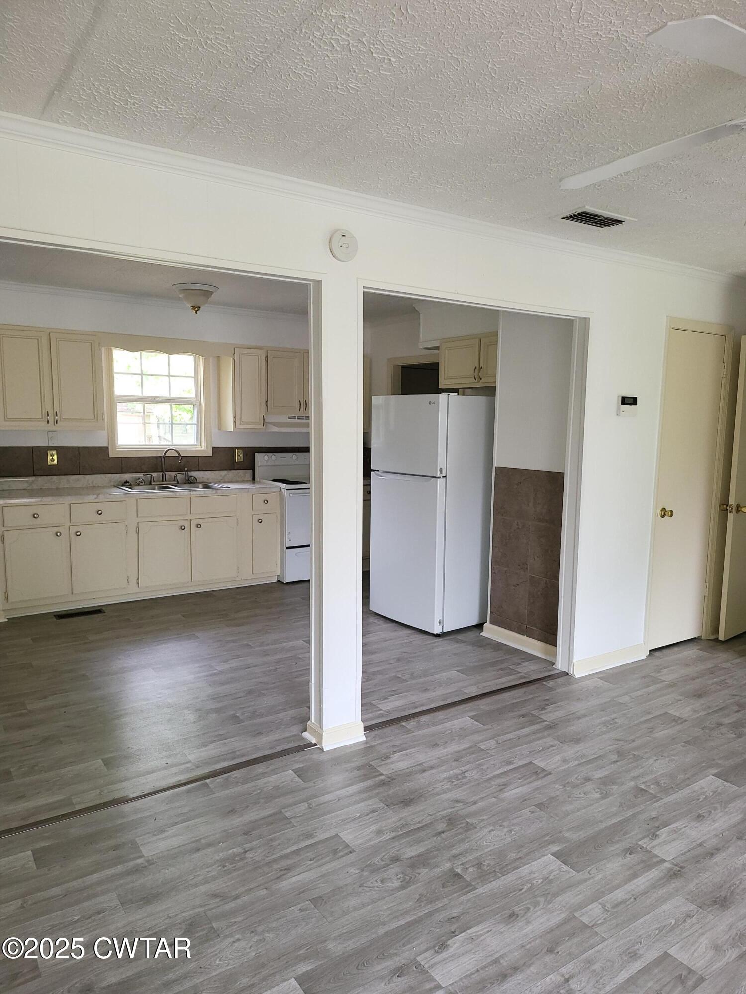 200 Cross Street Bolivar, TN 38008 - Photo 3 of 12 a view of a kitchen with a sink and dishwasher cabinets