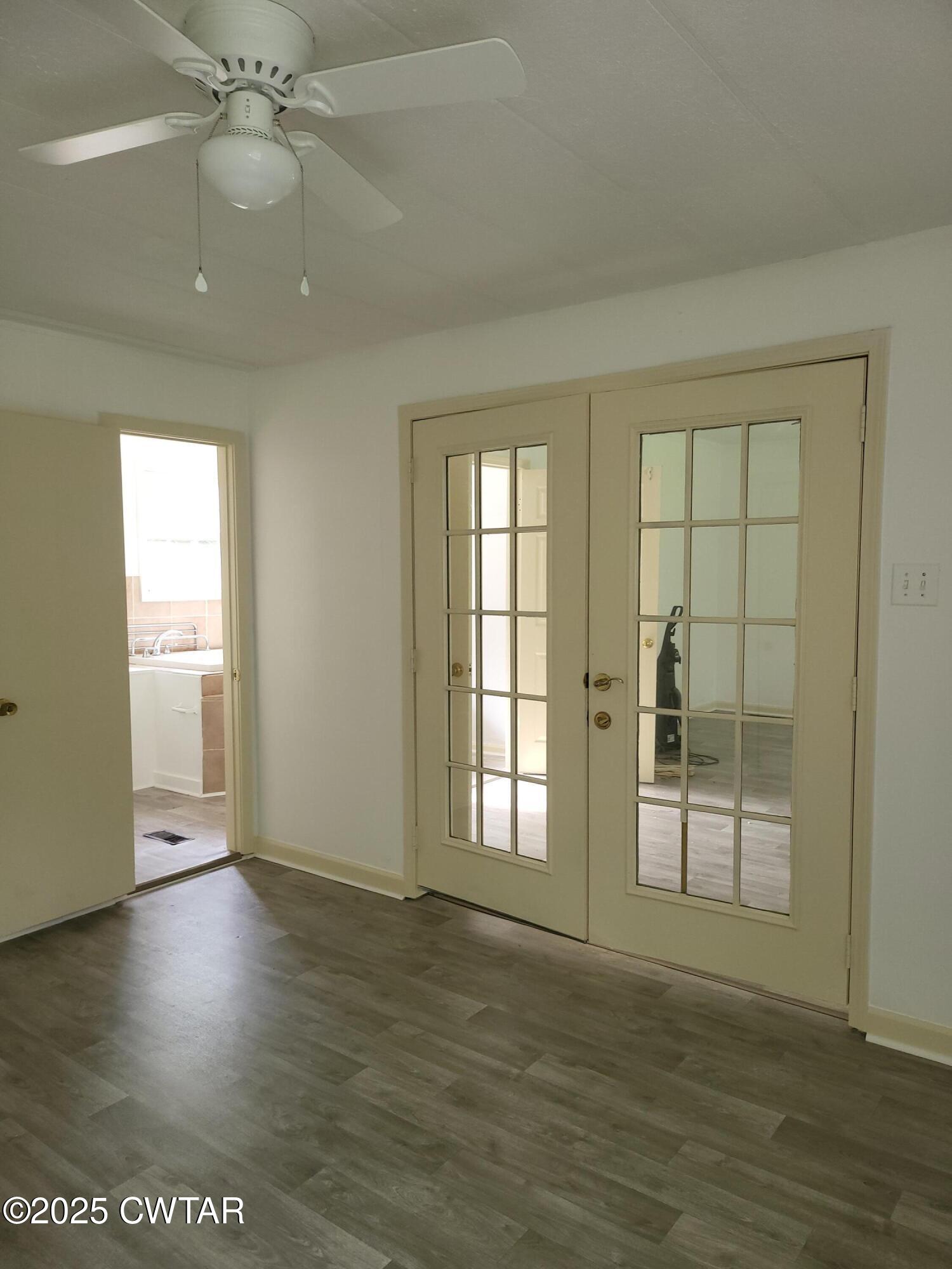 200 Cross Street Bolivar, TN 38008 - Photo 6 of 12 an empty room with wooden floor and windows