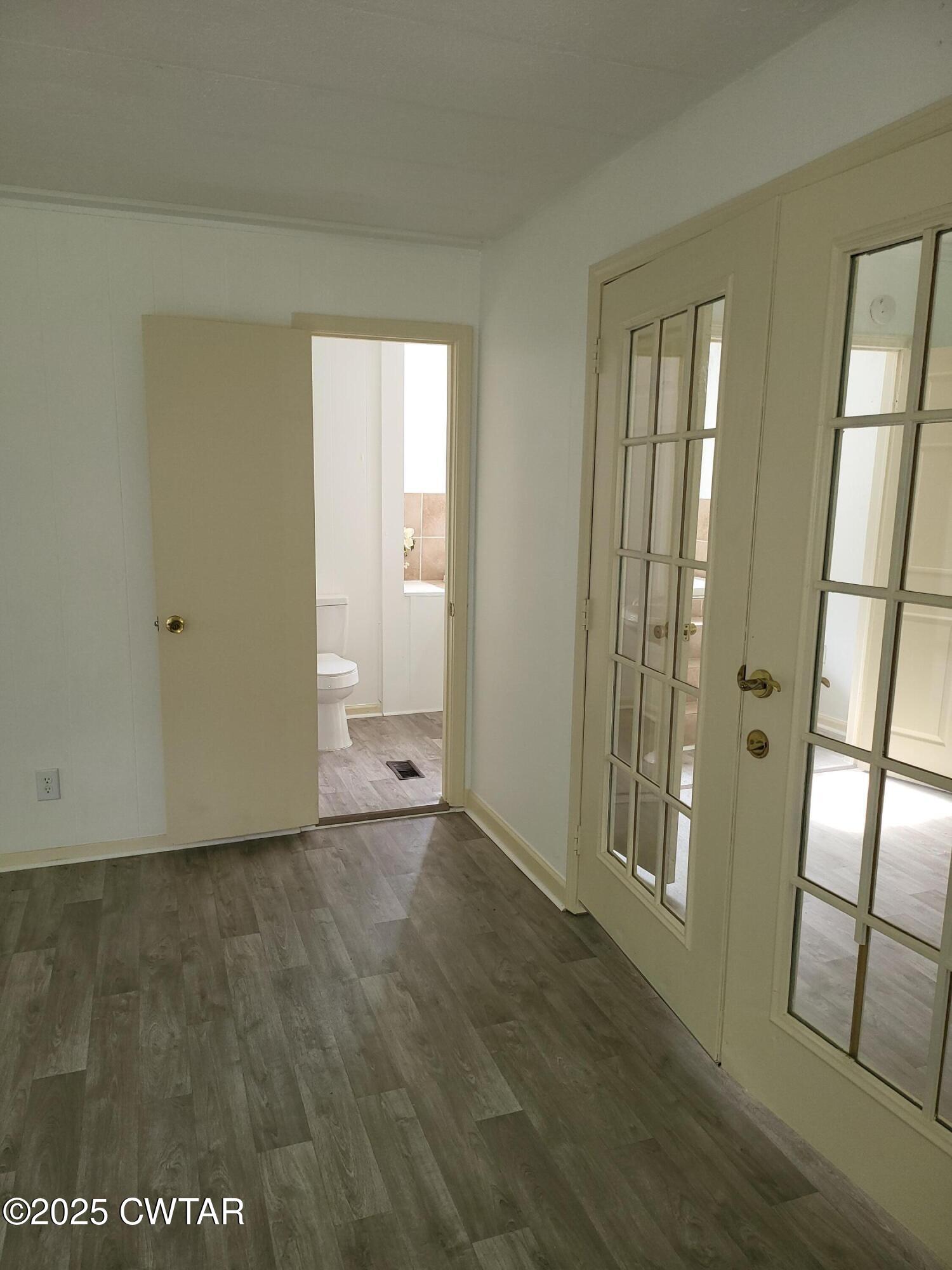 200 Cross Street Bolivar, TN 38008 - Photo 7 of 12 a view of an empty room with window and wooden floor