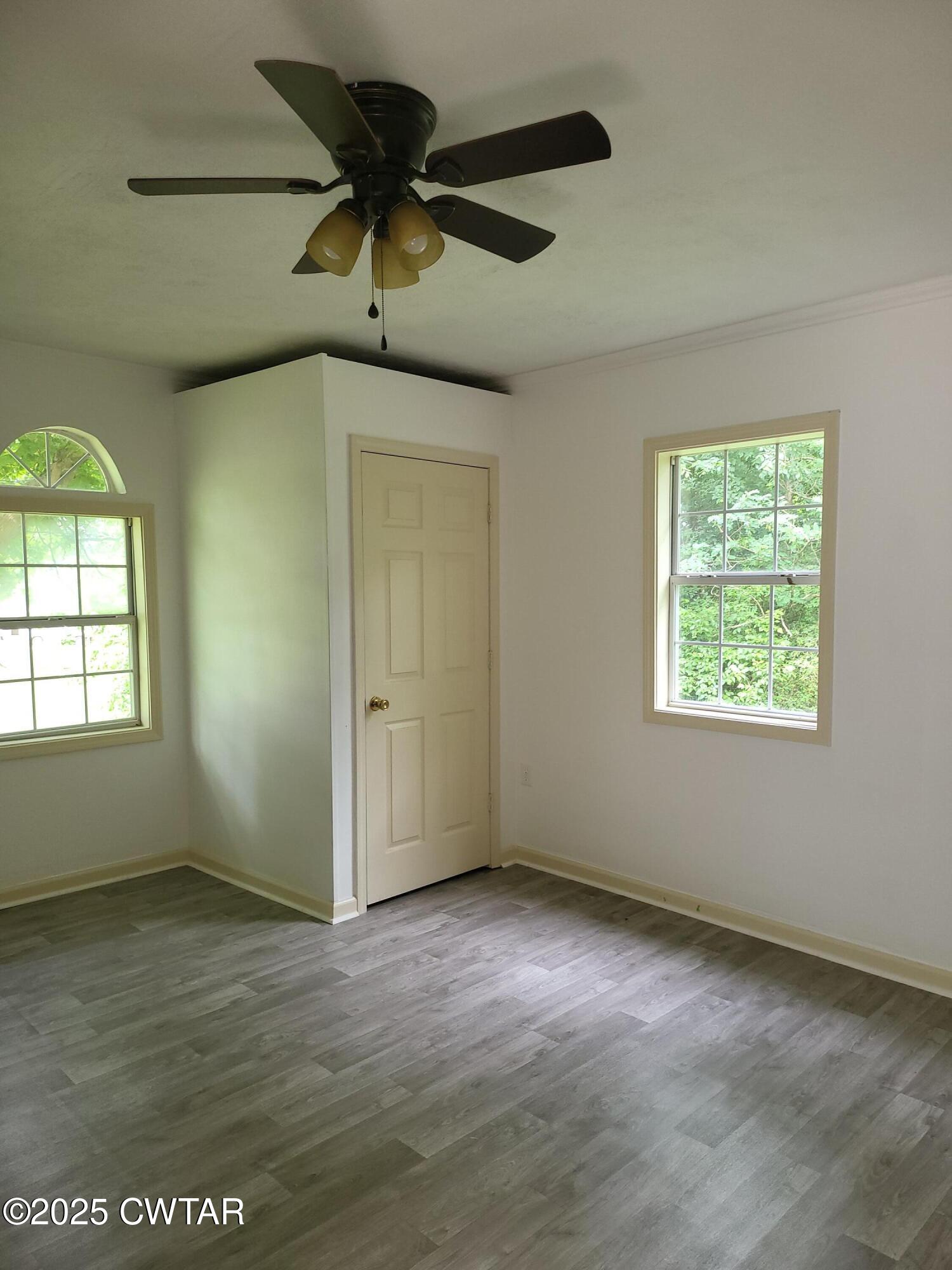 200 Cross Street Bolivar, TN 38008 - Photo 8 of 12 an empty room with a ceiling fan and window