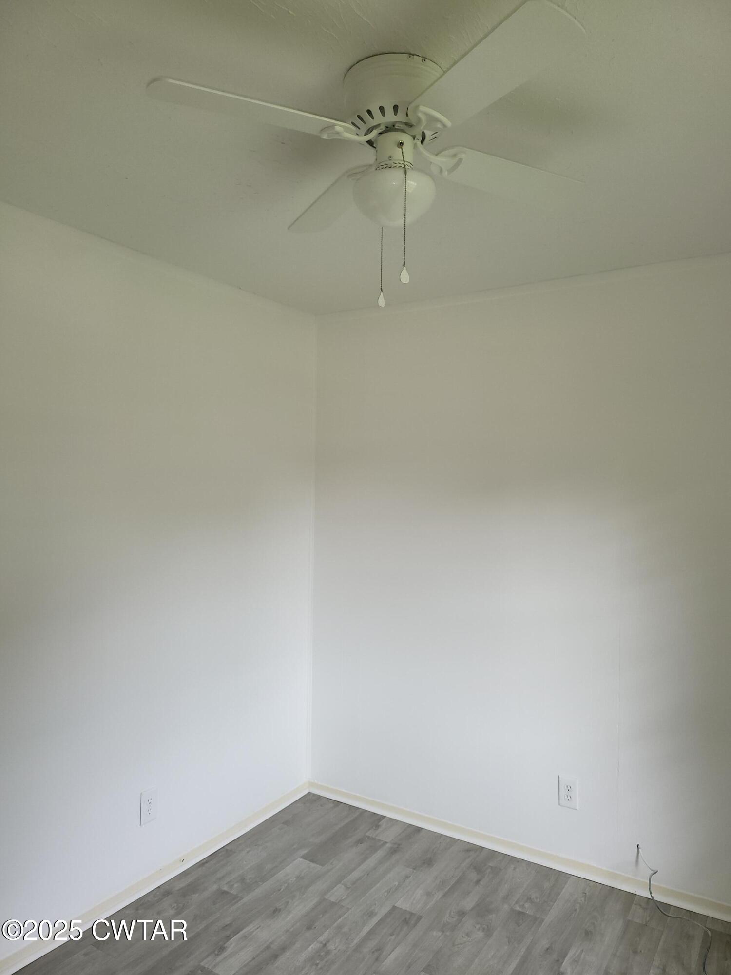 200 Cross Street Bolivar, TN 38008 - Photo 10 of 12 a view of a room with wooden floor and fan