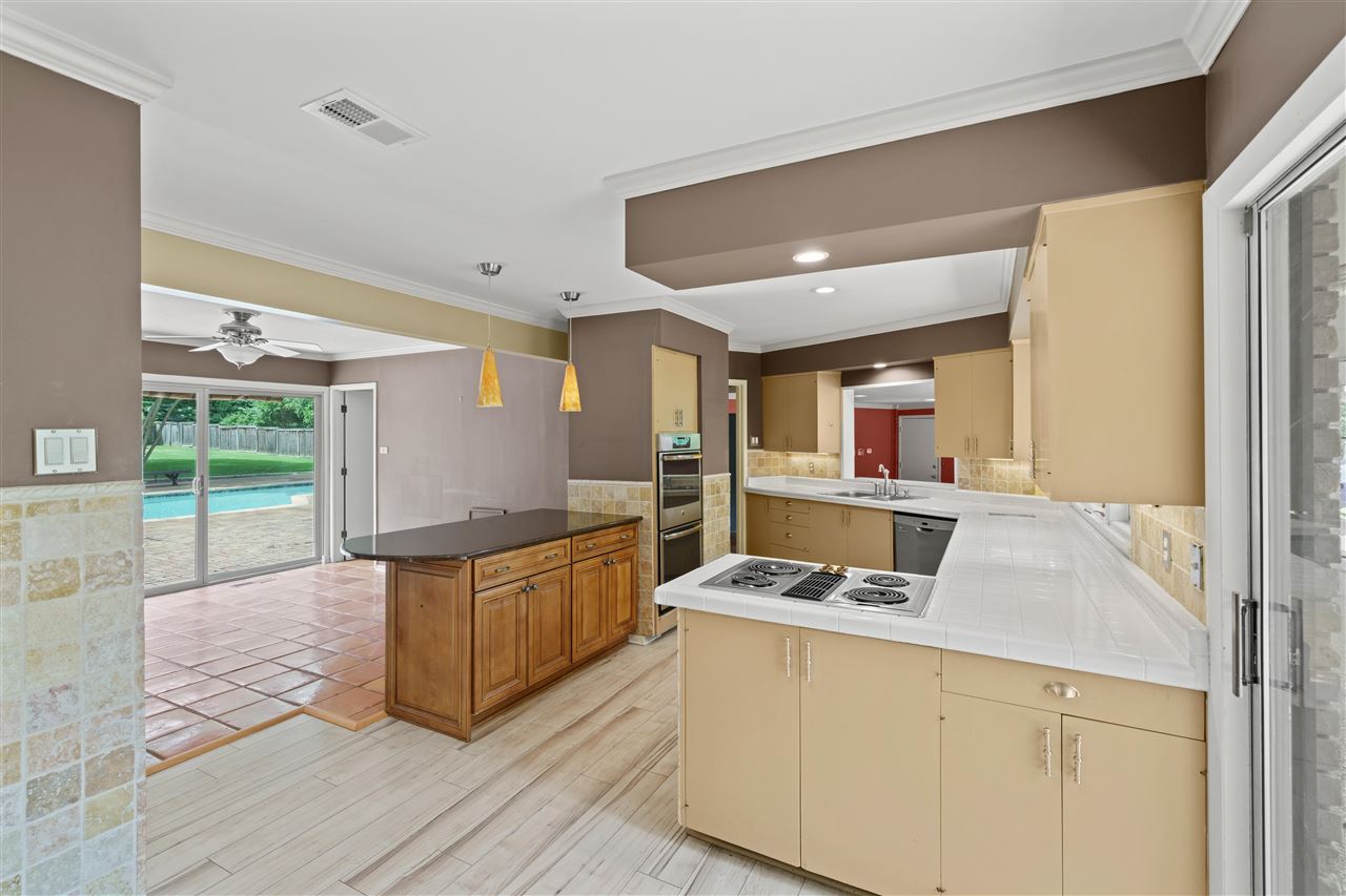 5341 Rich Road Memphis, TN 38120 - Photo 14 of 25 34 Cabinets/13 Drawers in Kitchen, plus a Pantry! Pendant Lighting over Island, Breakfast Area and Sliding Doors to Pool/Patio.