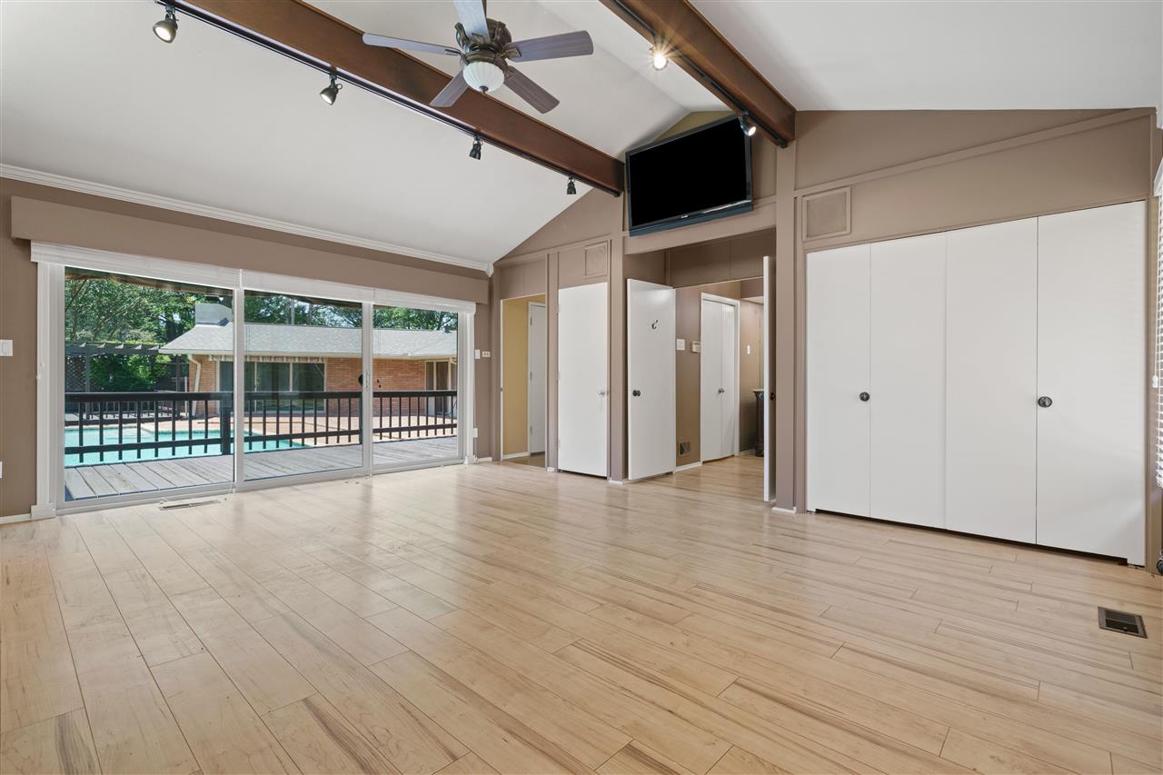 5341 Rich Road Memphis, TN 38120 - Photo 16 of 25 Spacious 2015 Primary Bedroom with 11 ft Vaulted and Beamed Ceiling plus Wall of Windows to the Rear Yard