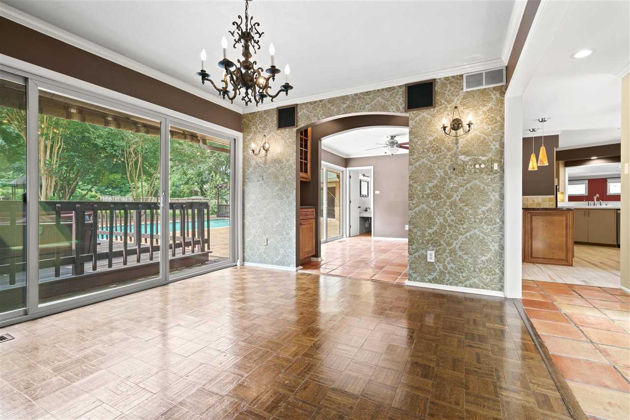 5341 Rich Road Memphis, TN 38120 - Photo 6 of 25 Dining Room with Parquet Floor, Brick Wall Accent, and Wall of Windows overlooking Pool and Rear Yard