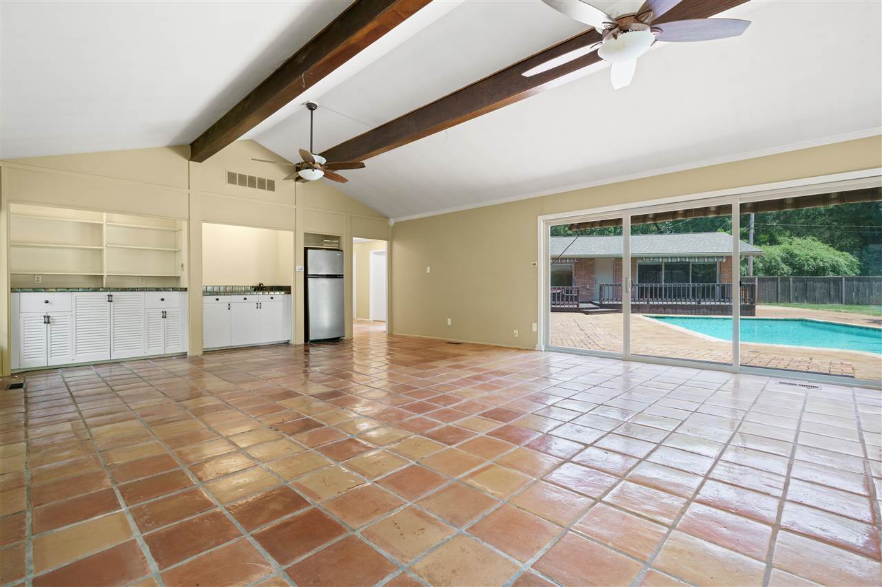 5341 Rich Road Memphis, TN 38120 - Photo 7 of 25 25x19 Great Room with Fireplace, Wet Bar with Refrigerator and Custom Built-Ins, and Sliding Glass Door with Wall of Windows Overlooking the Pool, Patios, Deck & Gazebo.