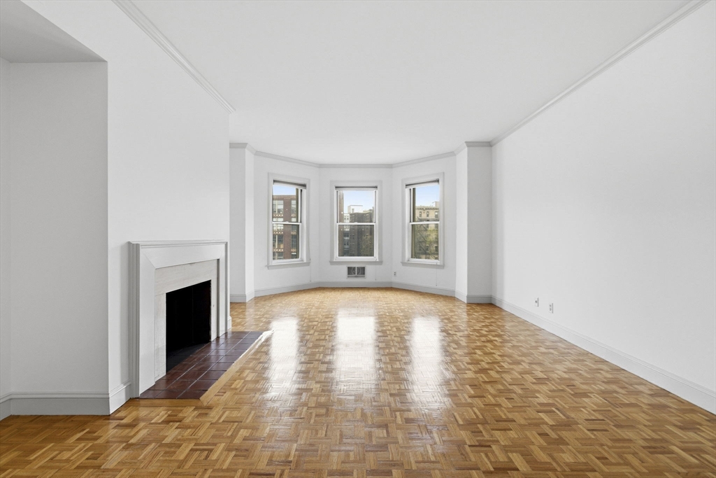416 Commonwealth Avenue, Unit 312 Boston, MA 02215 - Photo 6 of 24 a view of empty room with fireplace and wooden floor