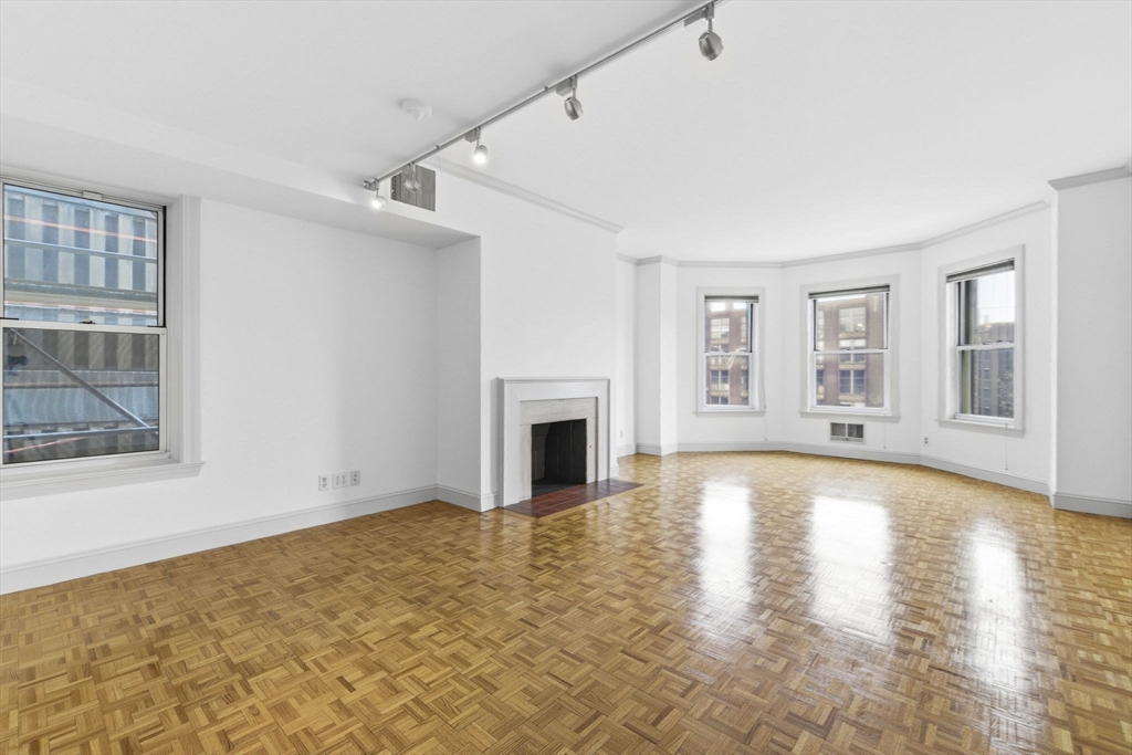 416 Commonwealth Avenue, Unit 312 Boston, MA 02215 - Photo 7 of 24 a view of empty room with wooden floor and fireplace
