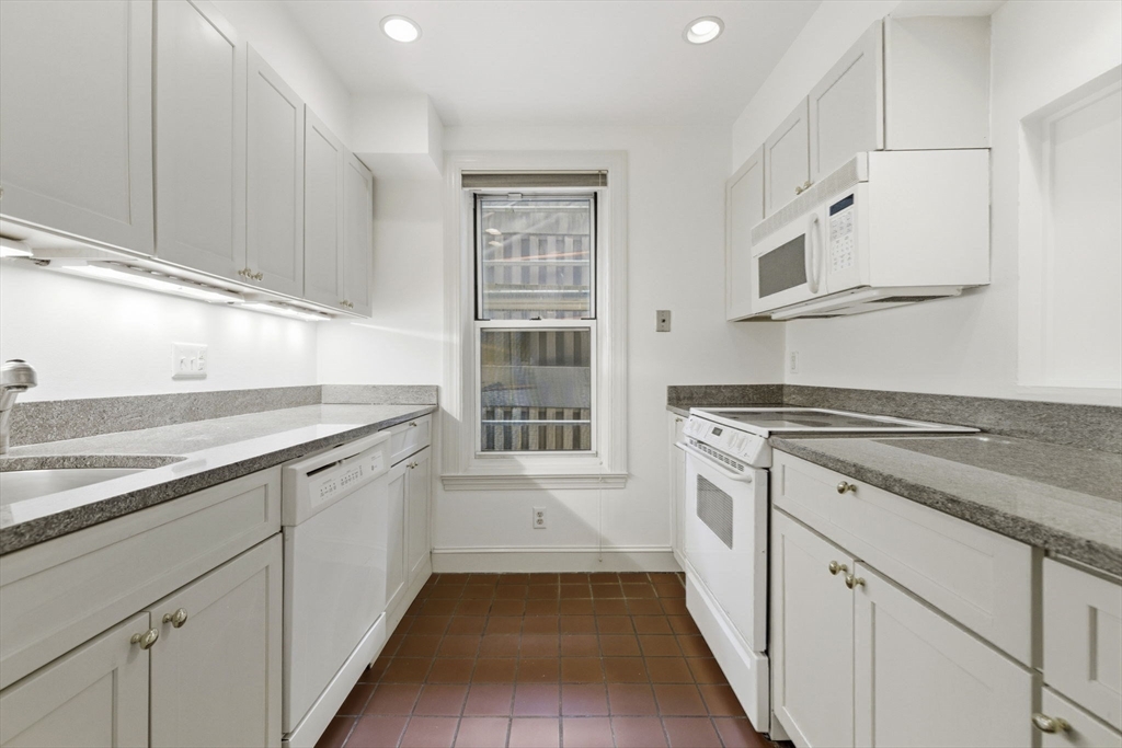 416 Commonwealth Avenue, Unit 312 Boston, MA 02215 - Photo 9 of 24 a kitchen with cabinets stainless steel appliances a sink and a window