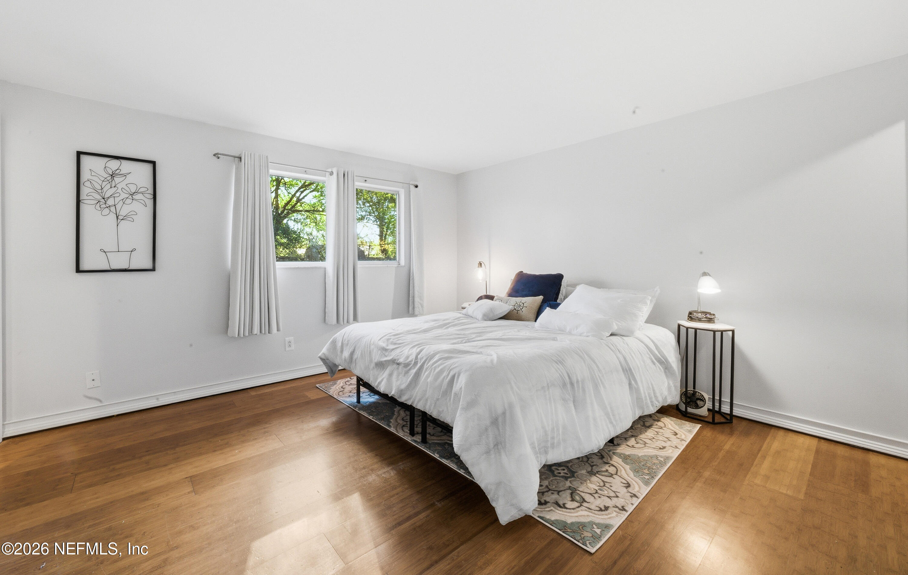 147 Knight Boxx Road Middleburg, FL 32068 - Photo 14 of 30 a bedroom with a bed and wooden floor