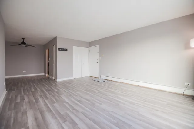 a view of an empty room and wooden floor