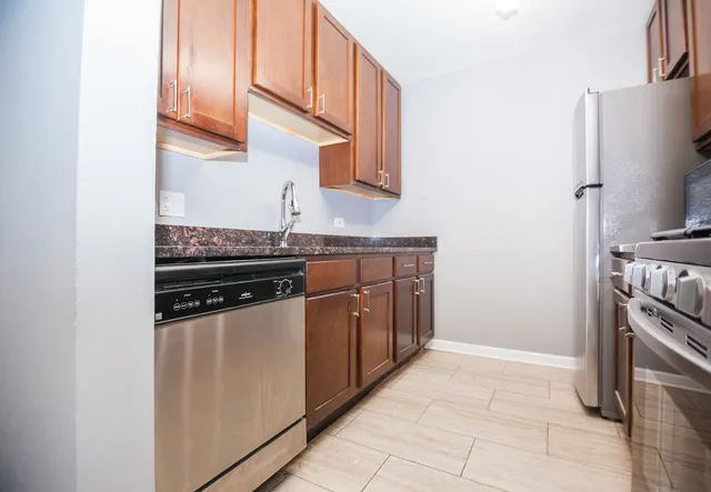 a kitchen with stainless steel appliances granite countertop a stove and a refrigerator