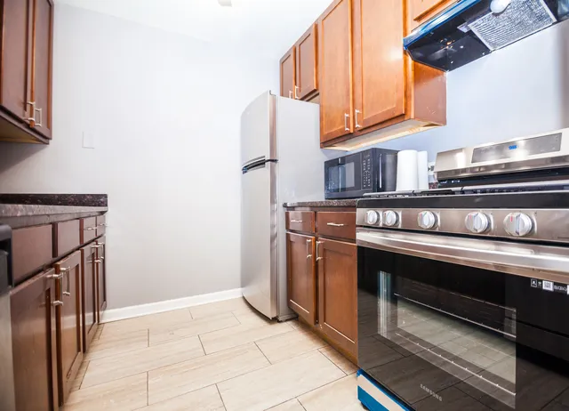 a stove top oven sitting inside of a kitchen