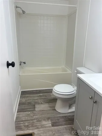 a bathroom with a toilet and a bath tub