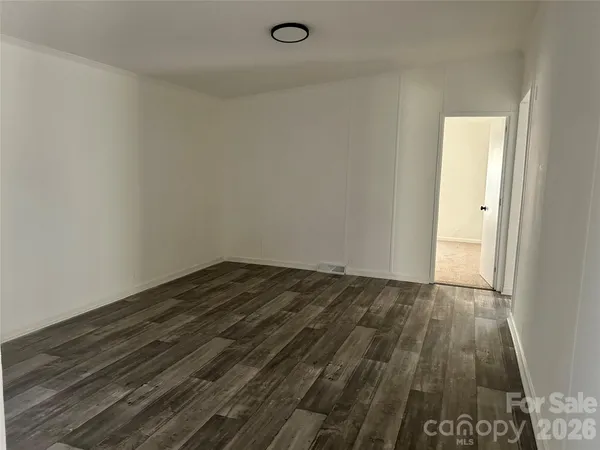 a view of an empty room and wooden floor