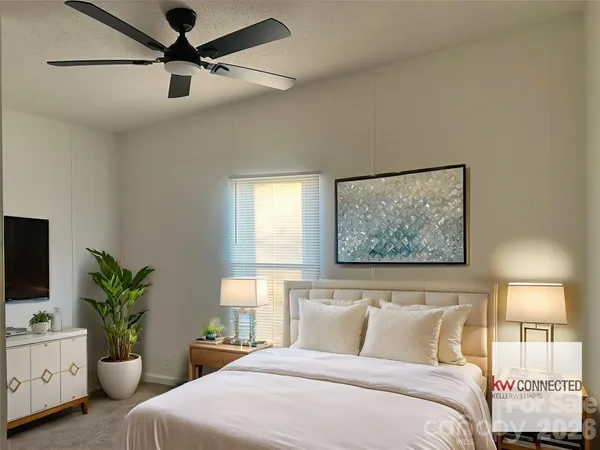 a bedroom with a bed and a potted plant