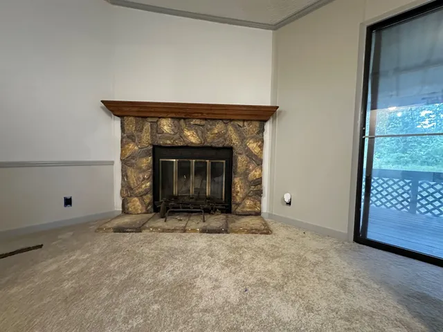a view of empty room with a fireplace