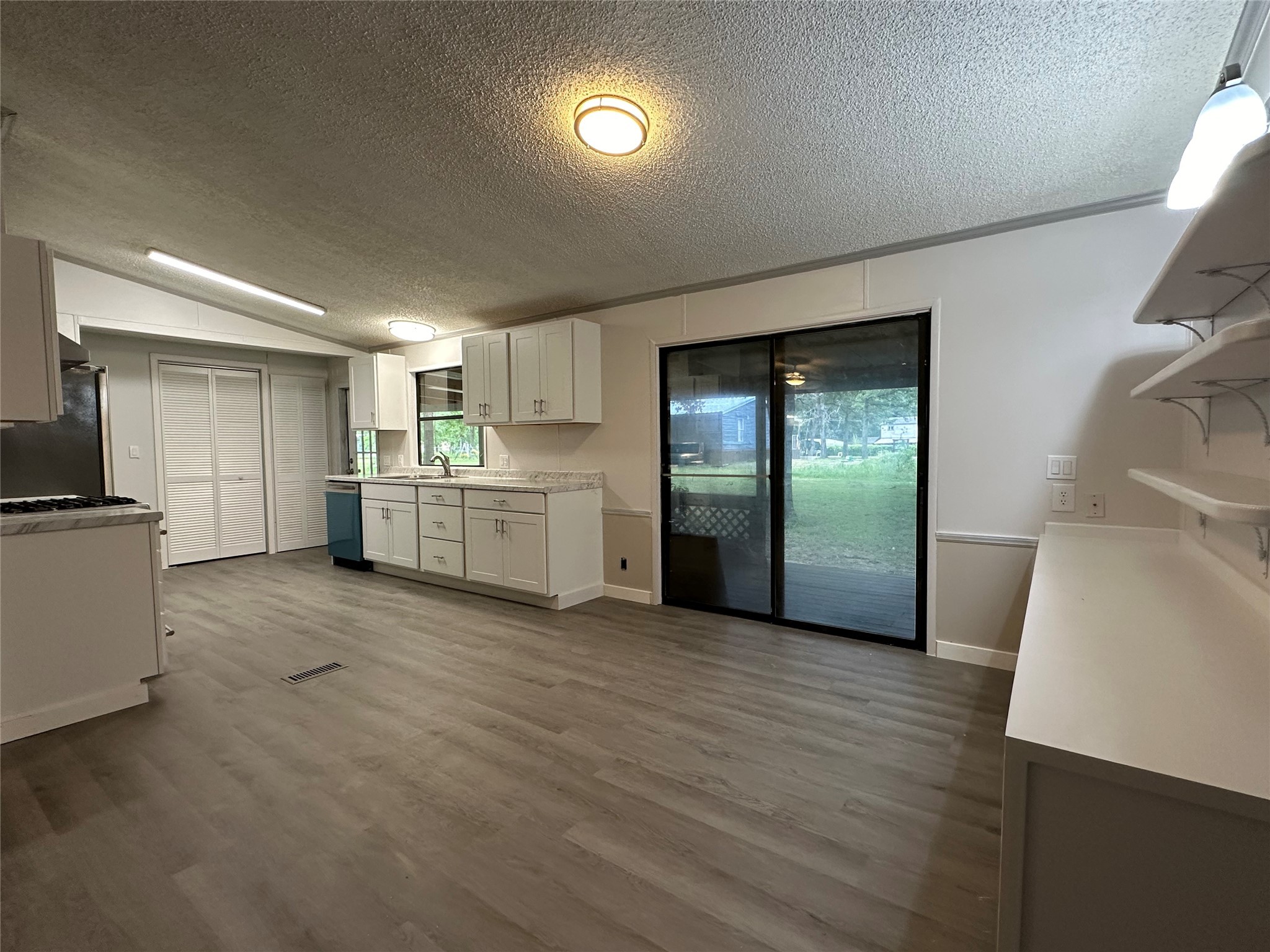 195 Charlies Lane Trinity, TX 75862 - Photo 19 of 25 a view of a kitchen with a sink a refrigerator and a stove top oven