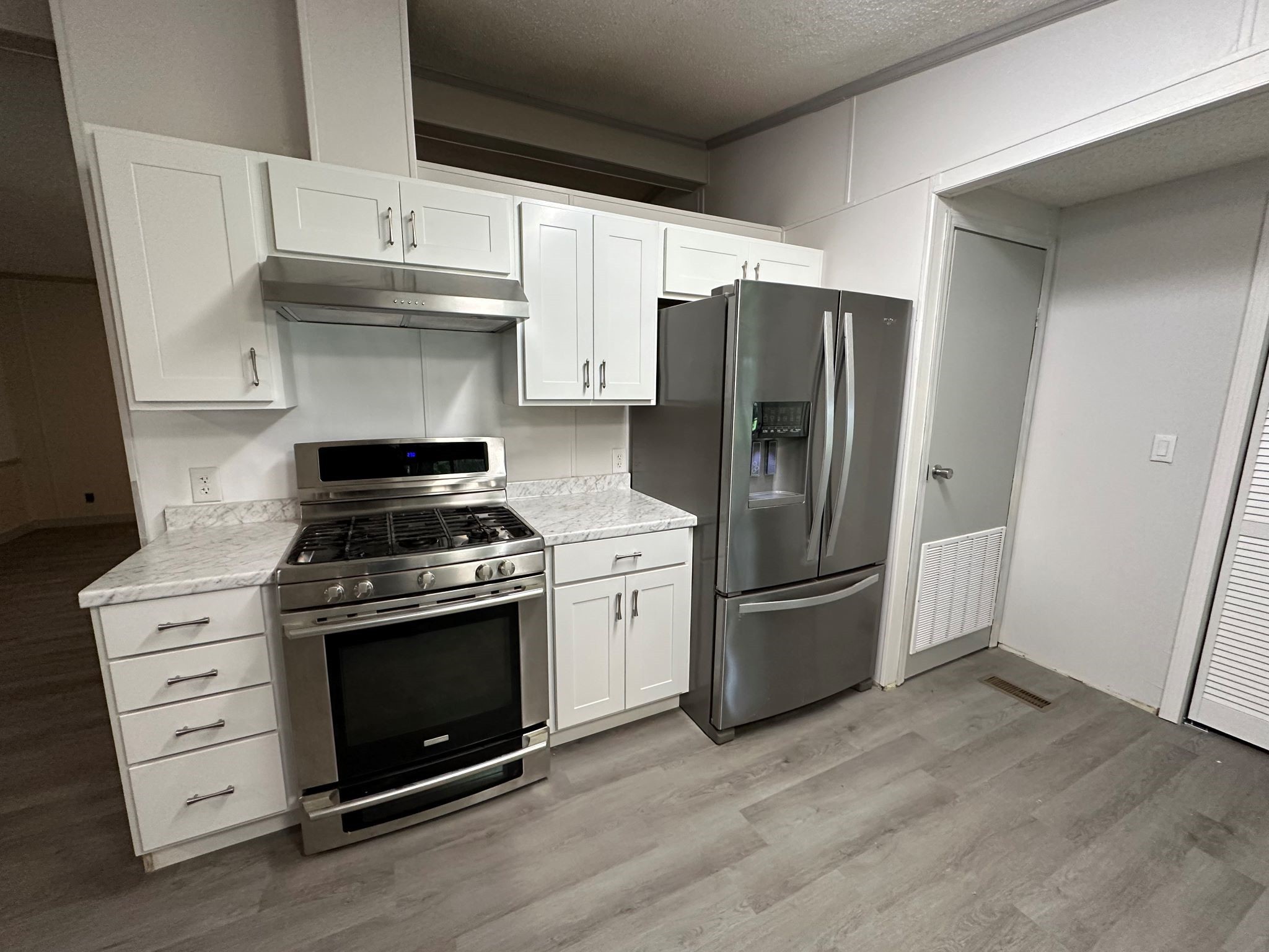 195 Charlies Lane Trinity, TX 75862 - Photo 20 of 25 a kitchen with stainless steel appliances a stove a refrigerator and cabinets