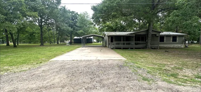 a view of a house with yard and sitting area
