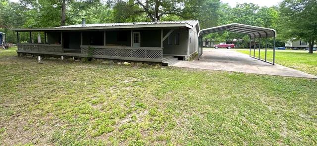 a view of backyard with barbeque grill and outdoor seating